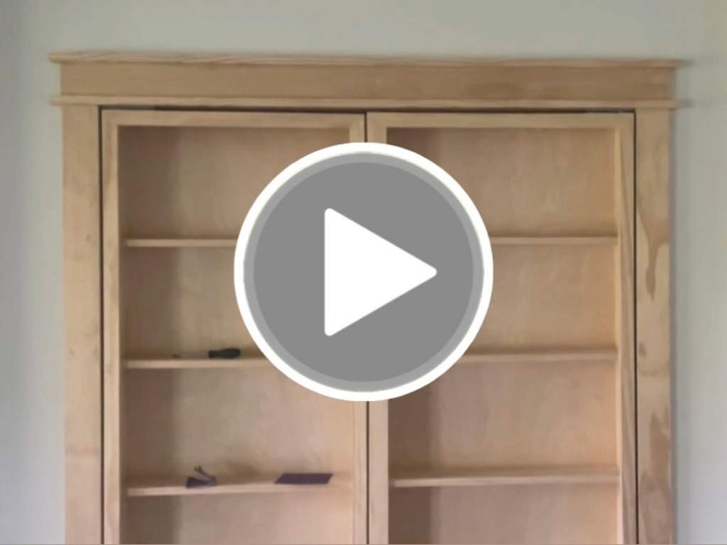 Video of a wooden shelf door accessing a hidden room.